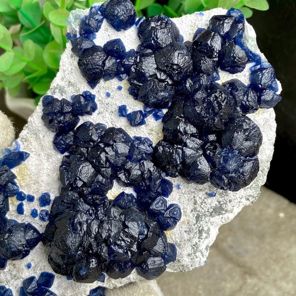 Navy-blue strawberry quartz balls on pale plate from Inner Mongolia, China, view 7 of 9