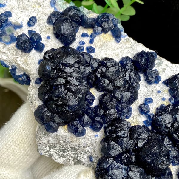 Navy-blue strawberry quartz balls on pale plate from Inner Mongolia, China, view 8 of 9