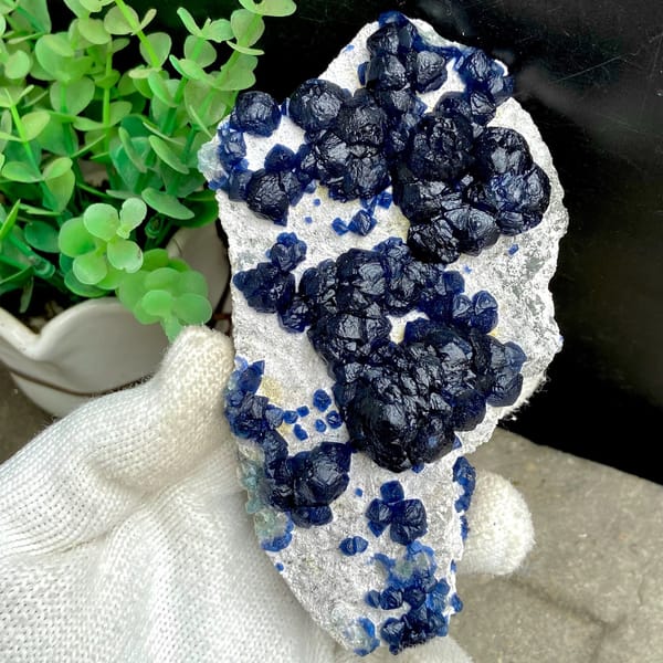 Navy-blue strawberry quartz balls on pale plate from Inner Mongolia, China, view 9 of 9
