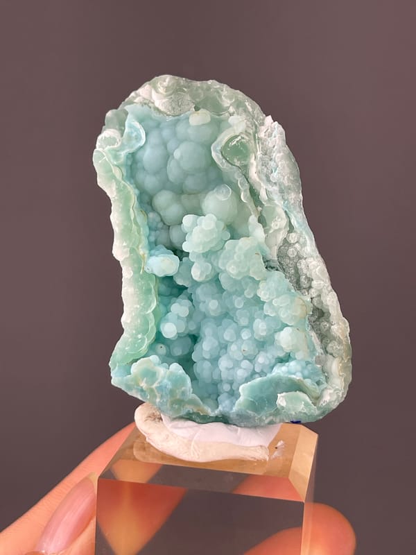 Strontianite specimen from Yunnan, China featuring pale blue botryoidal spheres
