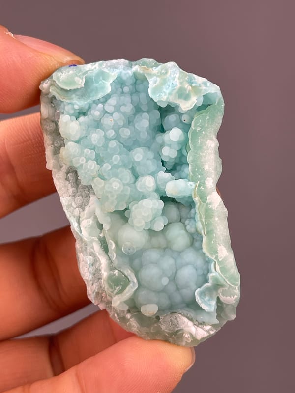Strontianite specimen from Yunnan, China bearing pale blue botryoidal spheres