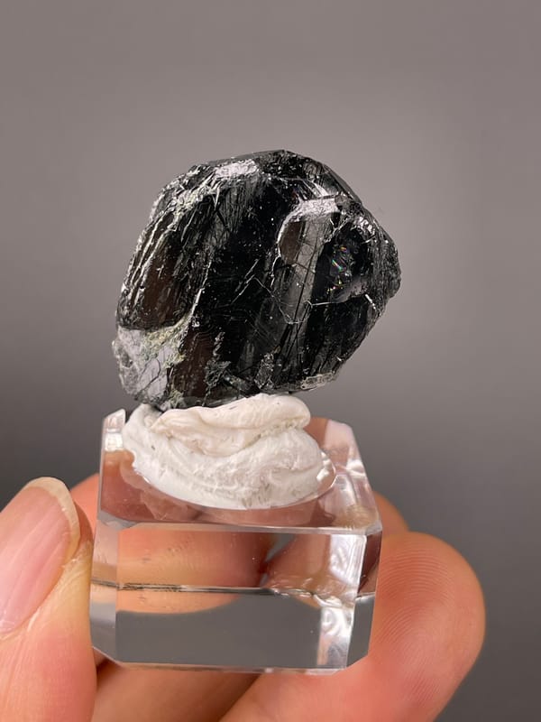 Tourmaline from Brazil: rotated view of grooved black faces and irregular edge.