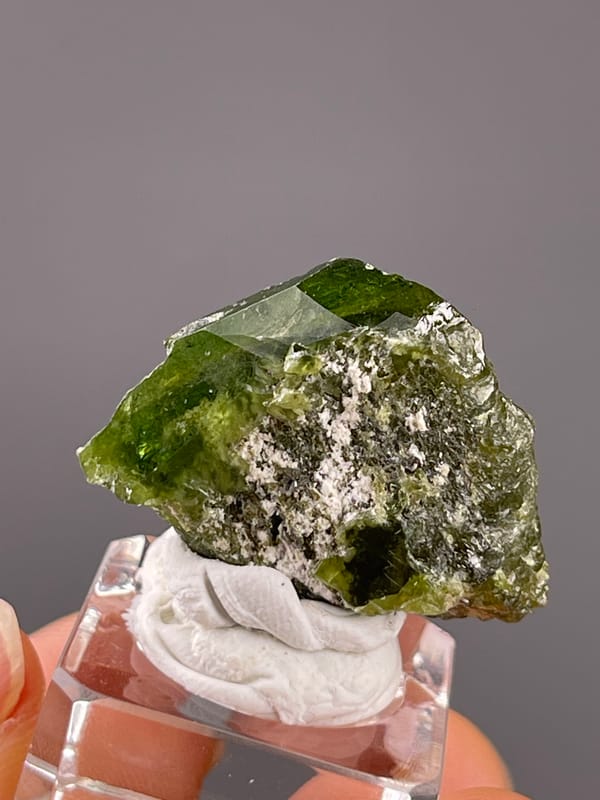 Tourmaline from Brazil: close view of translucent green edges and granular pale attachment.