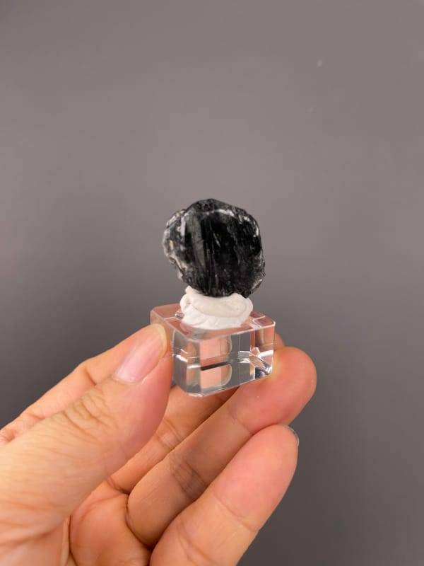 Tourmaline from Brazil: distant view of the compact rounded black outline.