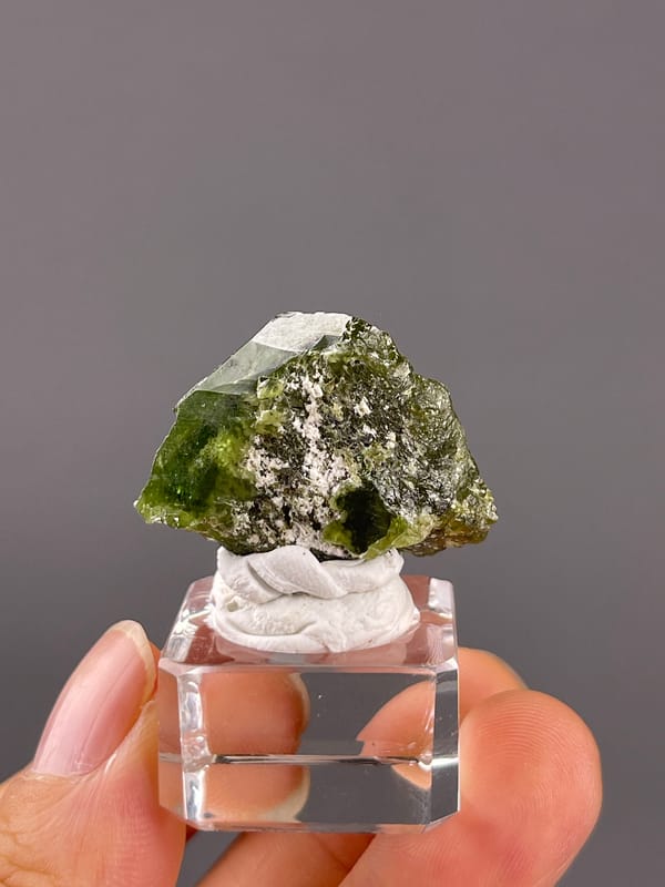 Tourmaline from Brazil: upright green face with patchy pale material.