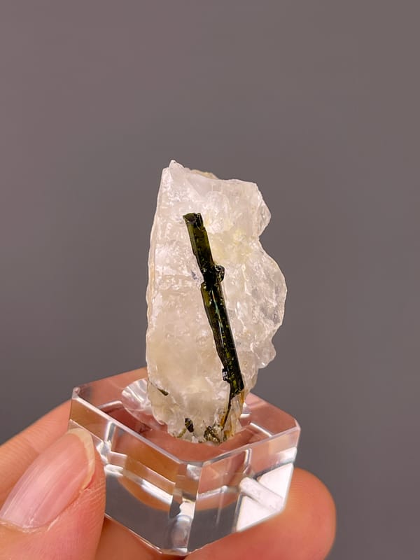 Tourmaline with quartz from Brazil: narrow side profile exposing a green dark crystal edge.