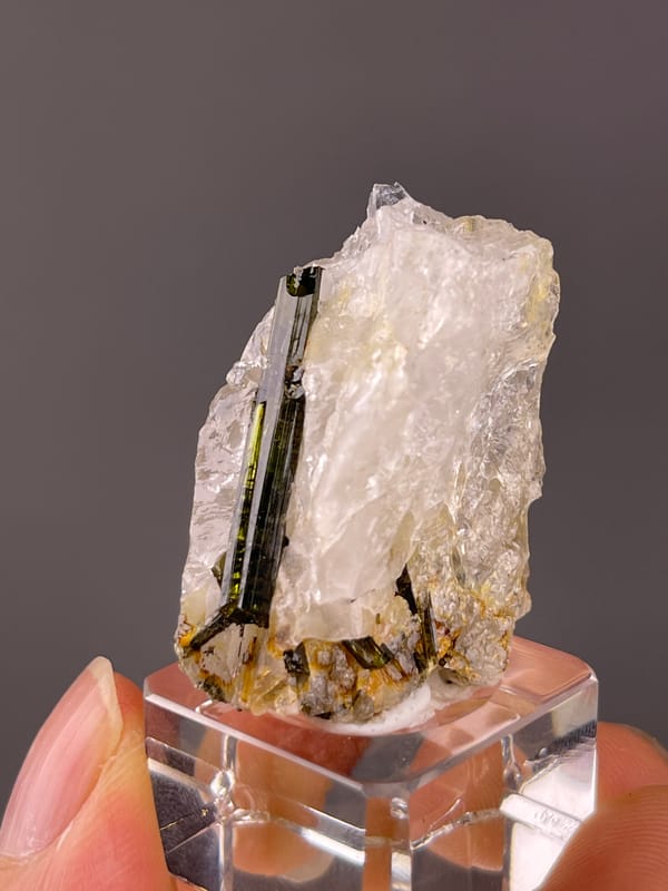 Tourmaline with quartz from Brazil: front close view with warm colored material near the lower edge.