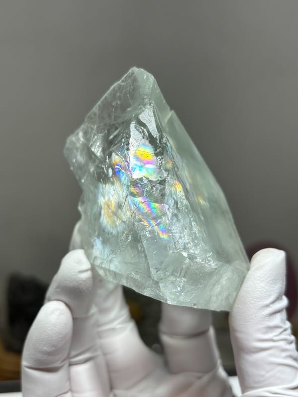 Transparent pale fluorite with rainbow flash from Xuebaoding, Sichuan, China, close-up of the crystal faces