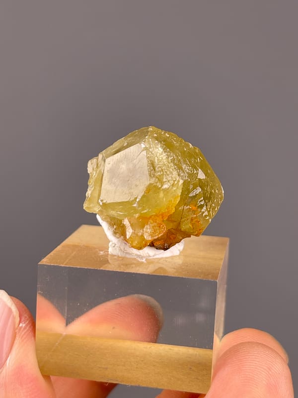 Unidentified specimen from Daye, Hubei, China: honey yellow crystal with a broad bright angular face.