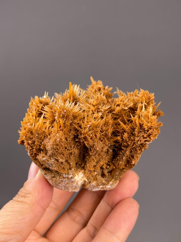 Unidentified specimen from Yunnan, China: orange brown sprays above a pale matrix edge.