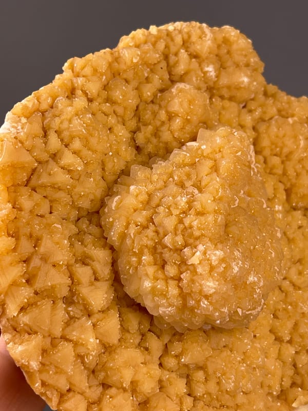 Unidentified specimen from Yunnan, China: close detail of crowded golden crystals around the center.