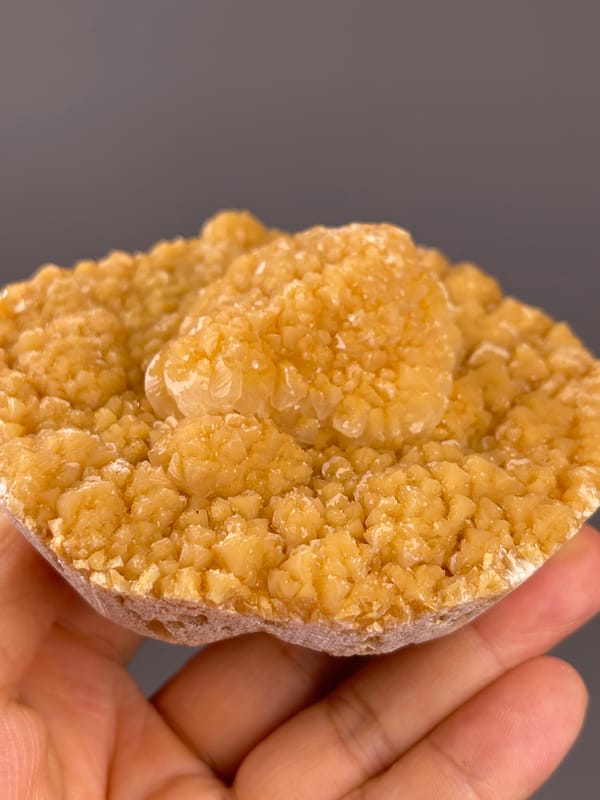 Unidentified specimen from Yunnan, China: side view of golden growths over a thin pale base.