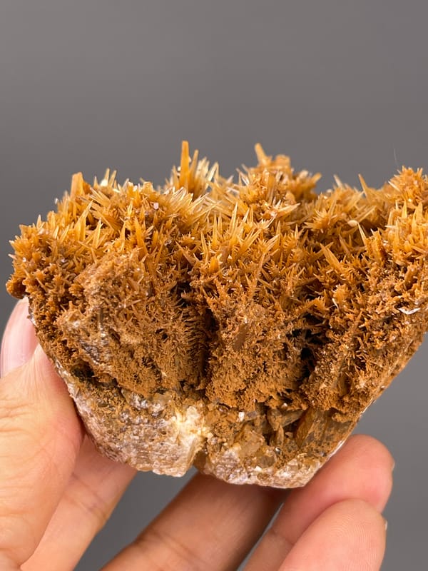 Unidentified specimen from Yunnan, China: fine sprays above a pale irregular lower rim.