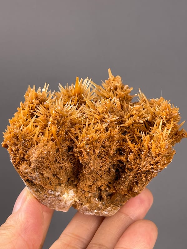 Unidentified specimen from Yunnan, China: angled front view of fine sprays and shadowed cavities.