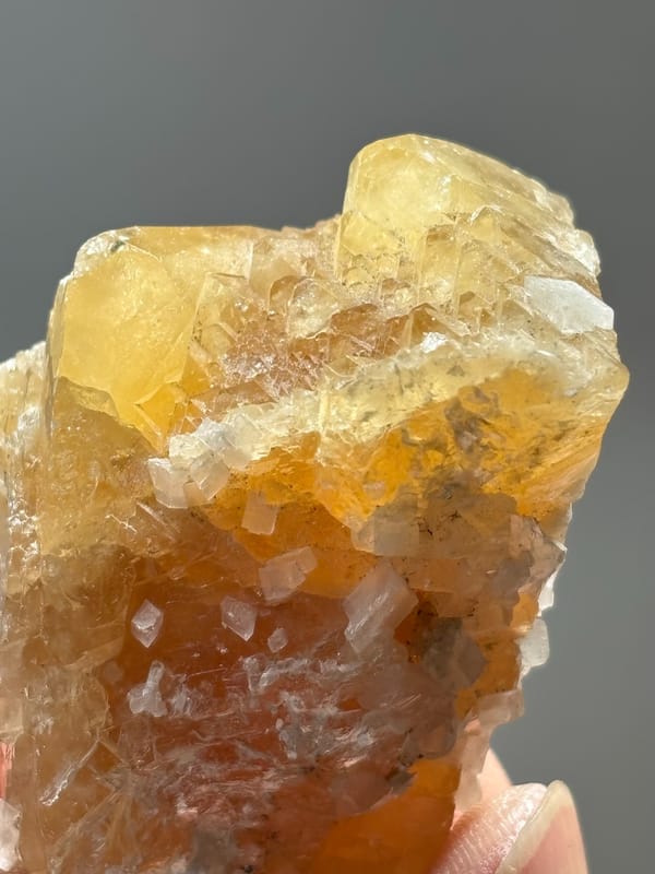 Unusual honey scheelite floater with calcite from Xuebaoding, Sichuan, China, reverse side