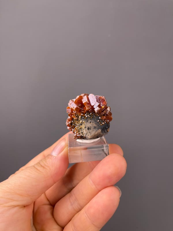 Vanadinite specimen from Morocco displaying orange-red hexagonal tabular crystals