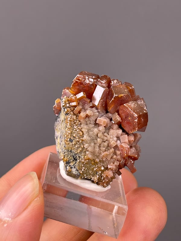 Vanadinite specimen from Morocco highlighting orange-red hexagonal tabular crystals
