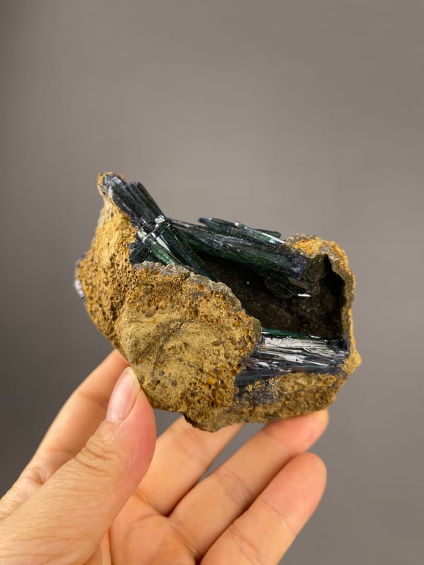 Vivianite specimen from Brazil showing dark green-black striated blades