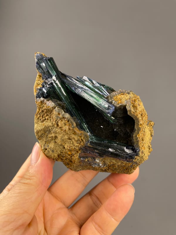 Vivianite specimen from Brazil presenting dark green-black striated blades