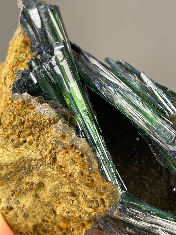 Dark green-black striated blades visible on vivianite specimen from Brazil