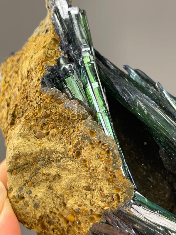 Vivianite specimen from Brazil displaying dark green-black striated blades