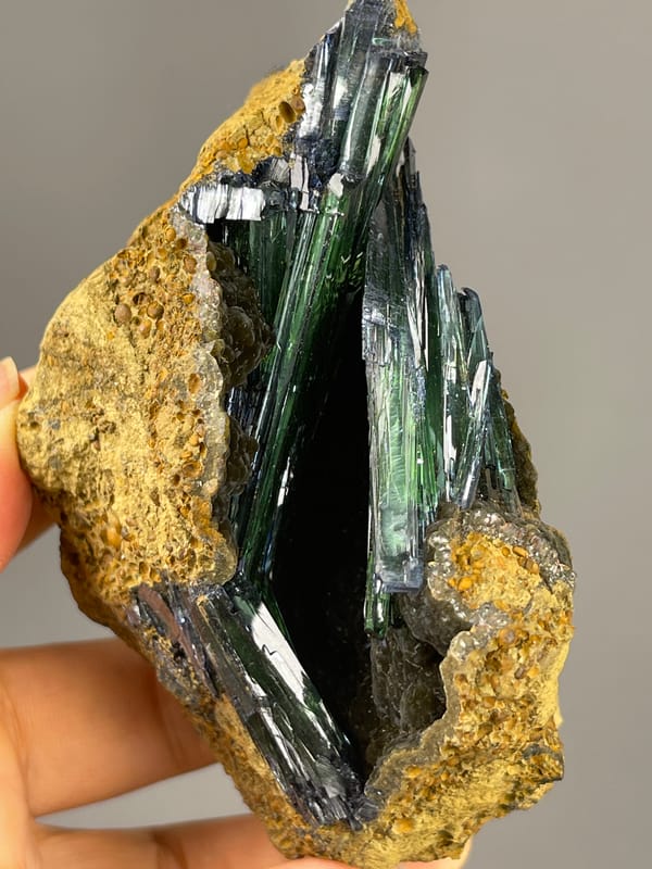 Vivianite specimen from Brazil highlighting dark green-black striated blades
