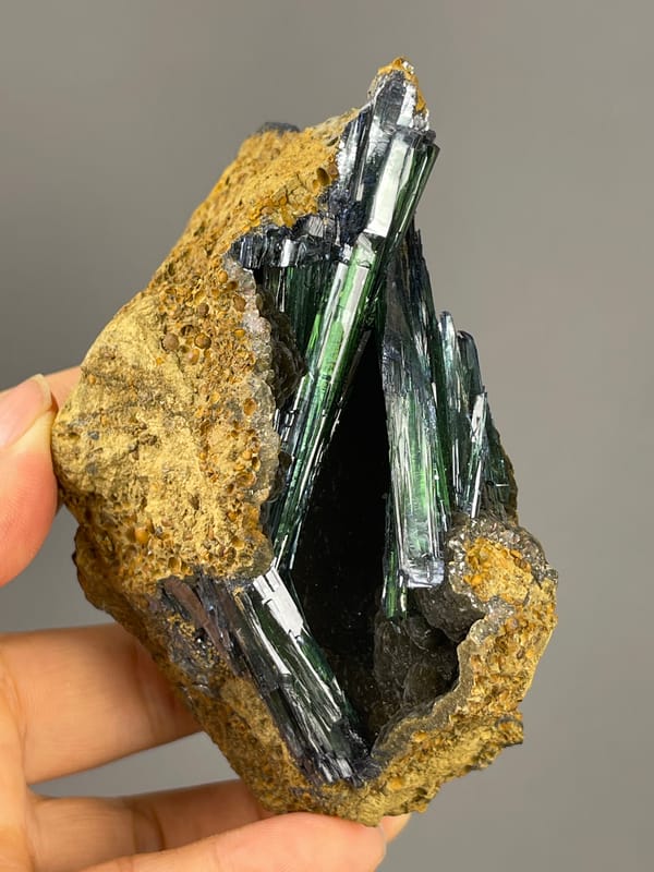 Vivianite specimen from Brazil, characterized by dark green-black striated blades