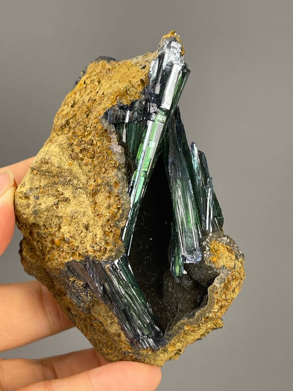 Vivianite specimen from Brazil bearing dark green-black striated blades