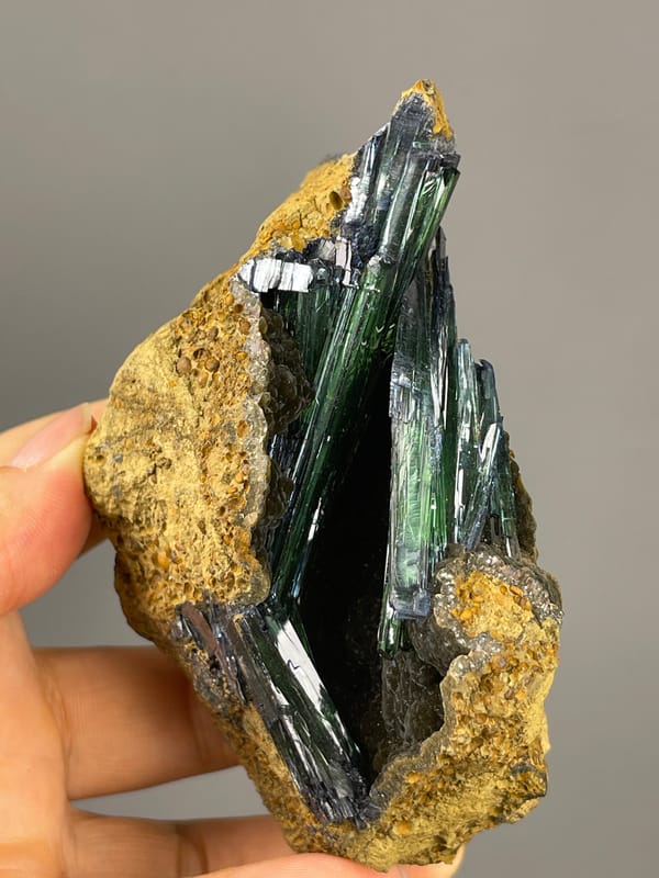 Vivianite specimen from Brazil showcasing dark green-black striated blades