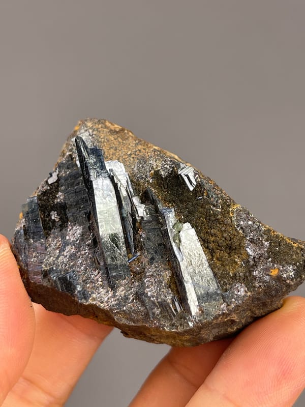Vivianite from Brazil: reflective crystal strips on a flat matrix face.