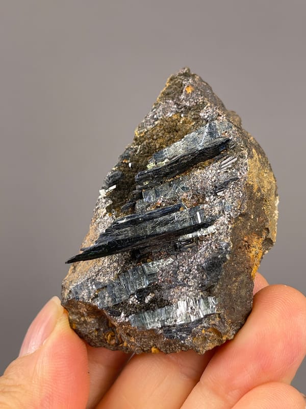 Vivianite from Brazil: oblique face with dark crystals and rusty edges.