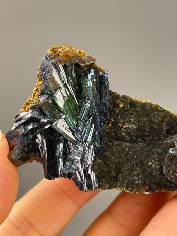 Vivianite from Brazil: front angle of the reflective dark green cluster.