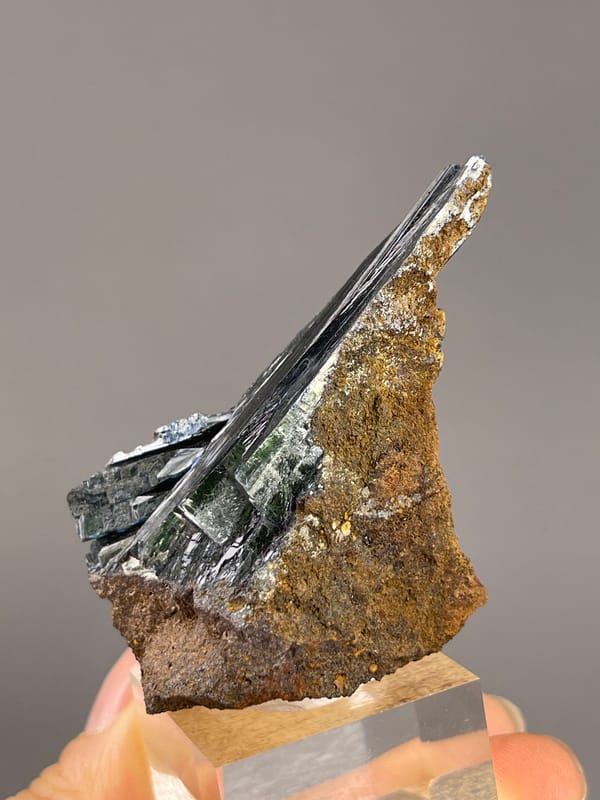 Vivianite from Brazil: oblique profile with long reflective faces.