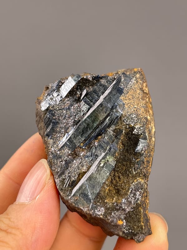 Vivianite from Brazil: oblique view across the long dark crystal faces.