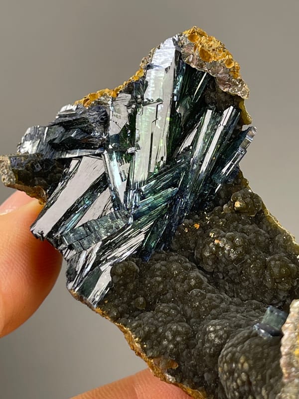 Vivianite from Brazil: upper angle across the dark green crystal spray.