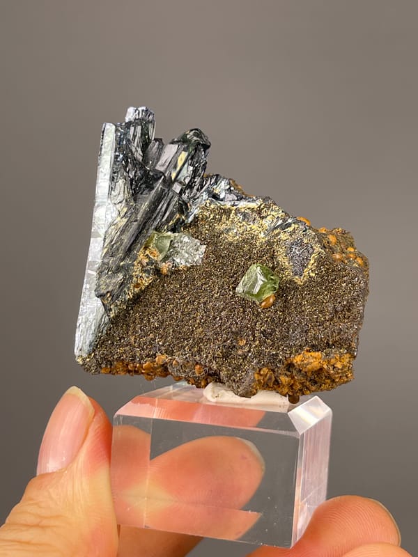 Vivianite specimen from Brazil featuring black striated blades on brown matrix