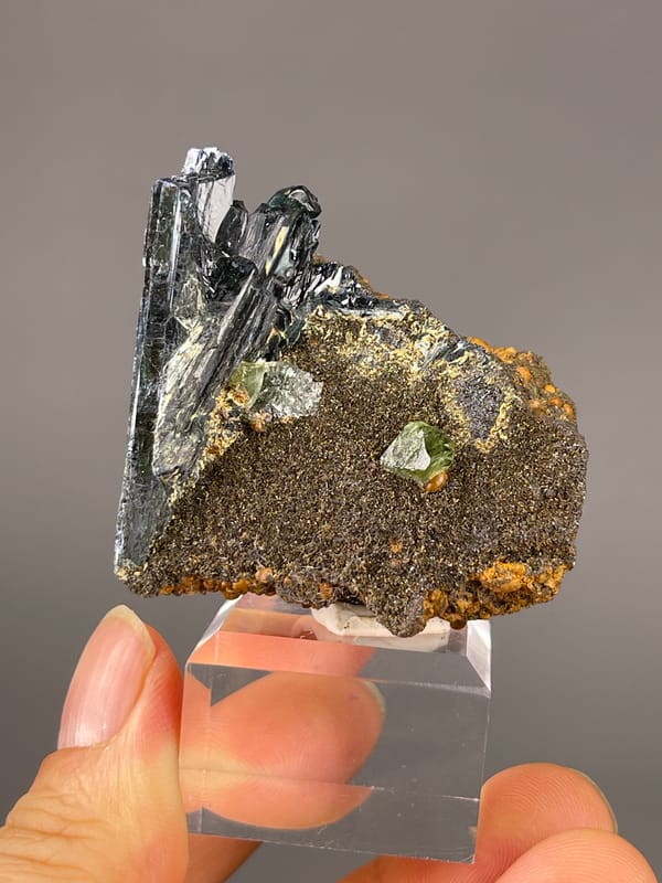 Vivianite specimen from Brazil showing black striated blades on brown matrix