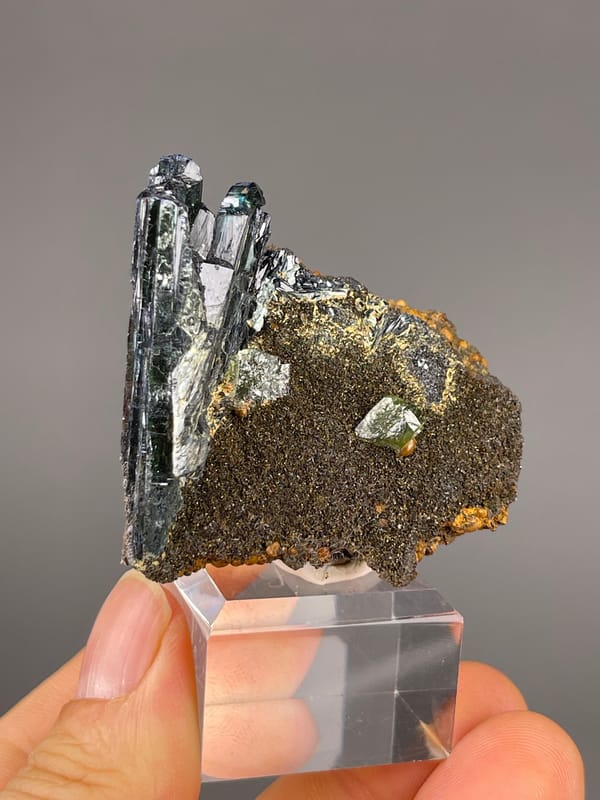 Vivianite specimen from Brazil, defined by black striated blades on brown matrix
