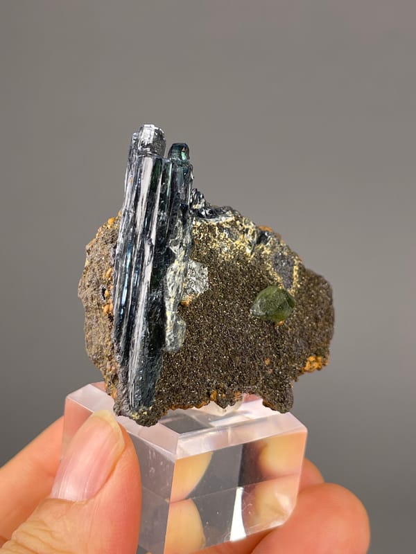 Vivianite specimen from Brazil presenting black striated blades on brown matrix