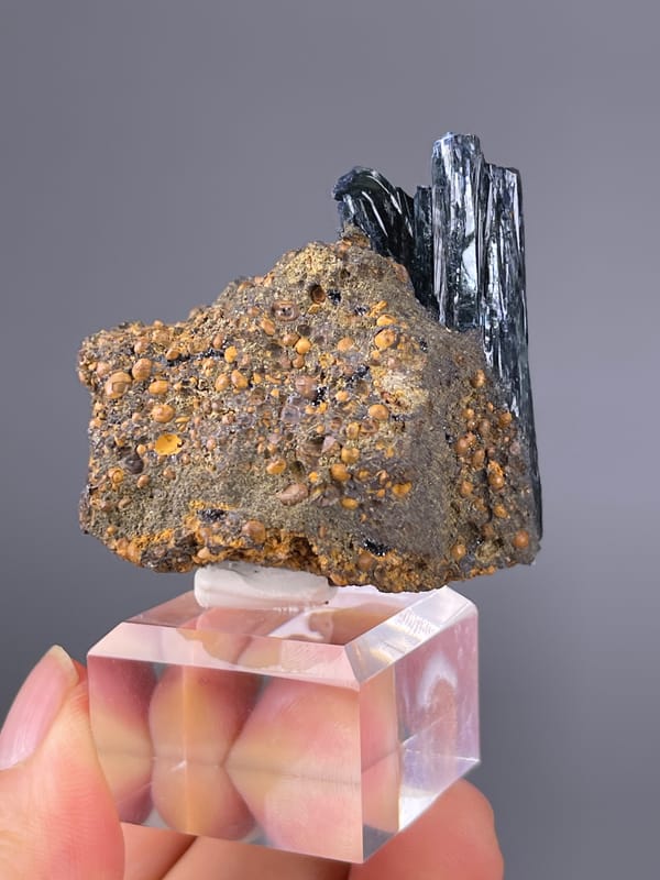 Vivianite specimen from Brazil displaying black striated blades on brown matrix