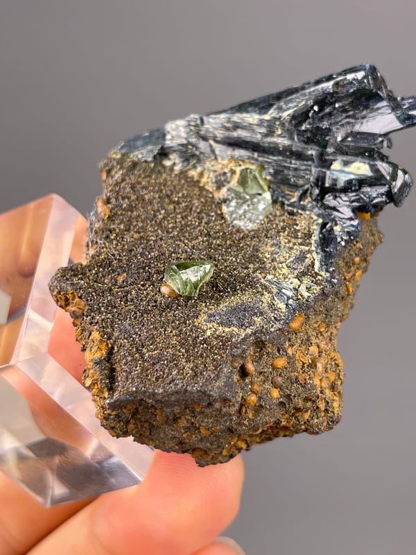 Vivianite specimen from Brazil highlighting black striated blades on brown matrix