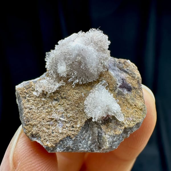 Two white chrysanthemum creedite sprays on grey rock from Guizhou, China, view 2 of 6
