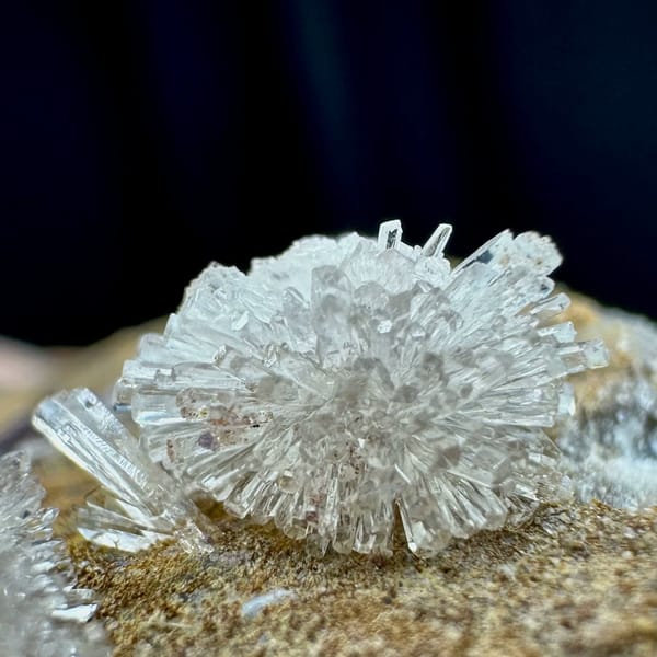Two white chrysanthemum creedite sprays on grey rock from Guizhou, China, view 4 of 6