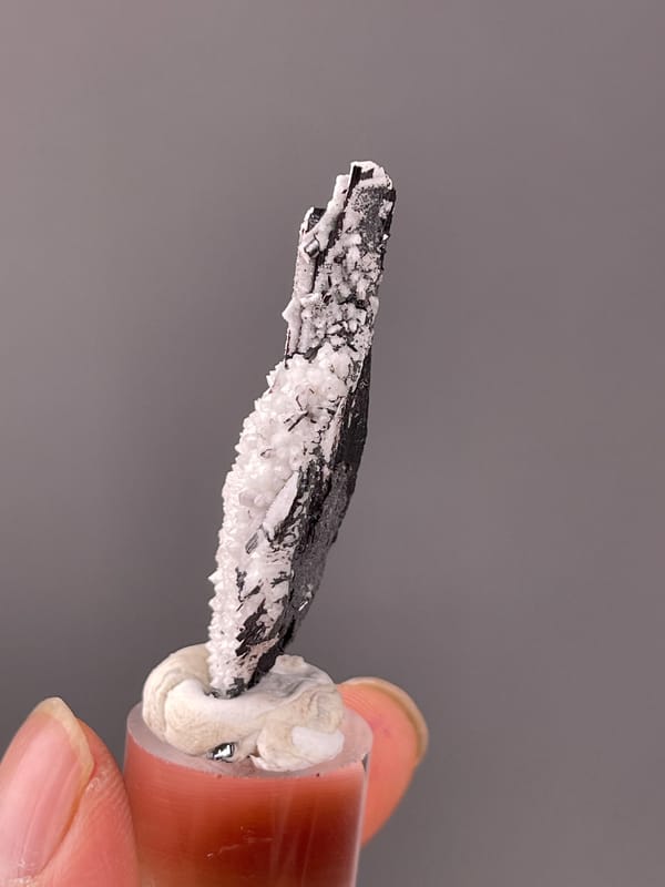 Wolframite-group with Quartz specimen from Yaogangxian, Hunan, China displaying steel-gray bladed crystals on quartz druse