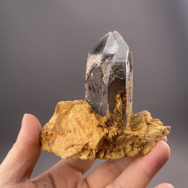 Small-cabinet quartz crystal from Lanwen Mine held in the hand