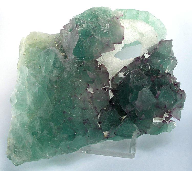 Natural green fluorite with purple color zoning from the Wushan mine, Jiangxi, China, showing banding that follows the crystal faces